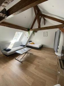 an attic room with two beds and a table at La Champenoise La Tannerie in Troyes +57 photos
