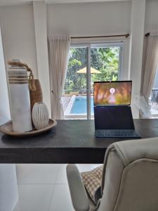 a desk with a laptop computer on top of it at Villa Tsukino Usagi in Koh Phangan