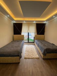 a bedroom with two beds and a window at Şahin Konağı in Degirmen +16 photos