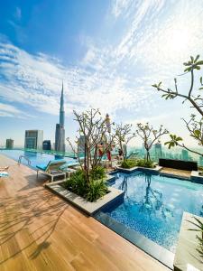 a pool on the roof of a building with a view at New Luxury 2 Bedroom with Burj Khalifa View & Spectacular Rooftop Infinity Pool Bar in Dubai