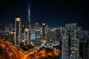 a view of a city at night with traffic at New Luxury 2 Bedroom with Burj Khalifa View & Spectacular Rooftop Infinity Pool Bar in Dubai