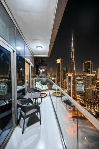 a balcony with a view of a city skyline at New Luxury 2 Bedroom with Burj Khalifa View & Spectacular Rooftop Infinity Pool Bar in Dubai