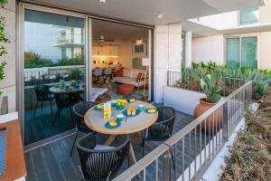 a patio with a table and chairs on a balcony at Bayline Paradise by Portucasa in Armação de Pêra