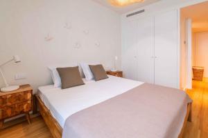 a white bedroom with a large white bed with two pillows at Bayline Paradise by Portucasa in Armação de Pêra +23 photos