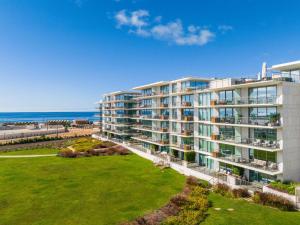 an aerial view of a building with the ocean in the background at Bayline Paradise by Portucasa in Armação de Pêra