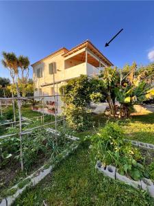 a garden in front of a house at Mia's Atelier in Kamária