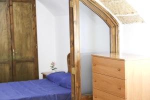 a bedroom with a mirror and a dresser at Corte De Tomasi- Centro storico in Gallipoli