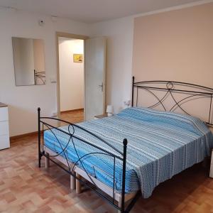 a bedroom with a bed with a blue comforter at Inti in Lucca