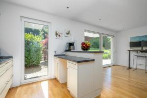 a kitchen with white walls and a counter top at Seeliebe und Gartenglück in Bodman-Ludwigshafen