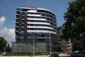 a large building with a sign on top of it at Апартамент 402 in Sliven