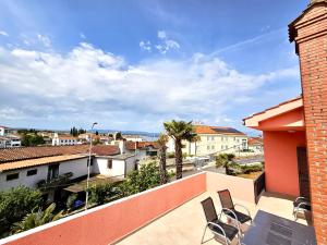 a balcony with chairs and a view of the ocean at Simanić Apartments in Malinska