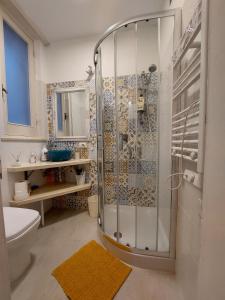 a bathroom with a shower with a toilet and a sink at Suite La TERRAZZA ILLUMINATA in Trapani +17 photos