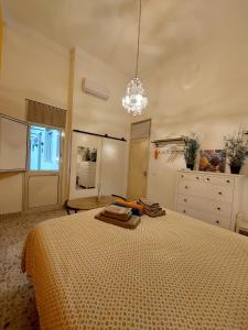 a bedroom with a bed and a chandelier at Suite La TERRAZZA ILLUMINATA in Trapani