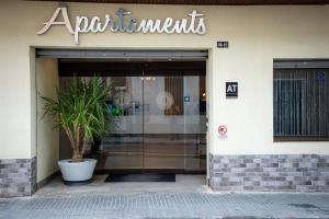 a store entrance with a potted plant in front of it at Apartamentos Comfort Calella in Calella +85 photos