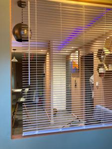 a view of a room through a window with blinds at Le DODU in Saint-Denis