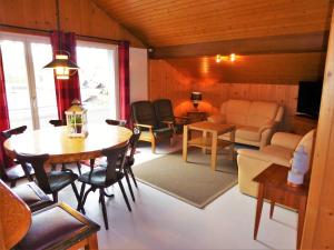 a living room with a table and chairs and a couch at Hotel Tell and Apartments in Interlaken