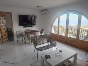 a living room with a table and a large window at Apartamento Buena Vista in Mojácar