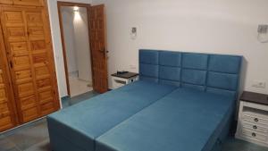 a large blue bed in a room with a door at Apartamento Buena Vista in Mojácar