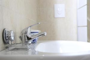a bathroom sink with a faucet on top of it at Corte Micetti 1- Centro storico in Gallipoli