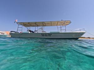 a boat sitting in the water in the ocean at Dive Art Oman in Ma‘ābīlah