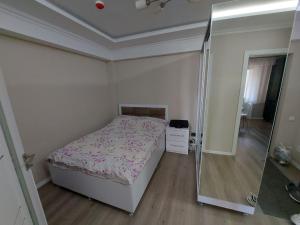 a bedroom with a bed and a walk in shower at Сдаю Квартиру in Chişinău