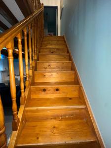 a stairway with wooden steps in a house at Le 8 appartement - Le Duplex III - parking sur demande in Mâcon +9 photos