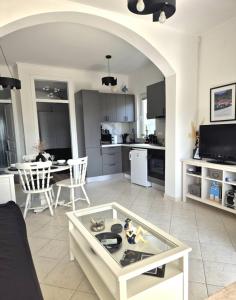 a living room with a table and a kitchen at Villa Mali Ston (3588) in Mali Ston