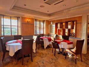 a restaurant with tables and chairs in a room at Boston Supreme Hotel in Boston