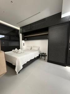 a bedroom with a large bed and a black wall at Old Town Flat in Patra
