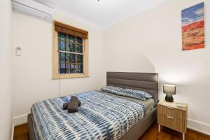 a bedroom with a bed and a window at Facilitated 4 BR House & ICC&Darling Harbour-8 mins walk in Sydney +8 photos