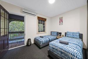 a bedroom with two beds and a balcony at Facilitated 4 BR House & ICC&Darling Harbour-8 mins walk in Sydney