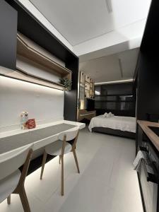 a room with a desk and a bed in the background at Old Town Flat in Patra