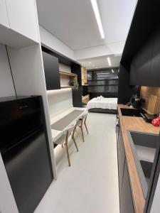 a kitchen with a couch and a bed in a room at Old Town Flat in Patra
