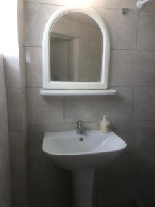 a bathroom with a sink and a mirror at Barreira Beachfront Room 5 in Kalamata +3 photos