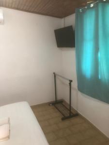 a room with a bed and a screen on the wall at Barreira Beachfront Room 5 in Kalamata