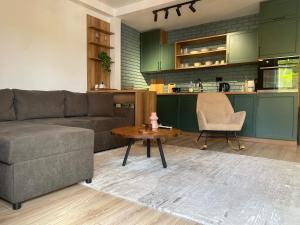 a living room with a couch and a table at Adora's Apartment Mavrovo in Mavrovo