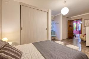 a bedroom with a large bed and a living room at Central + Bright Apartment in St. Julians in St. Julianʼs +18 photos