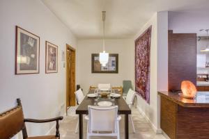 a dining room with a table and chairs at Central + Bright Apartment in St. Julians in St. Julianʼs