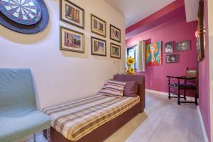 a bedroom with a bed and a clock on the wall at Central + Bright Apartment in St. Julians in St. Julianʼs