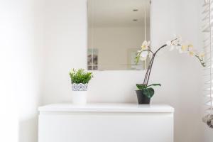 a bathroom with a white sink with flowers on it at Tolcarne Guest House in Newquay +60 photos