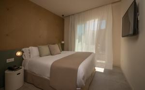 a bedroom with a large bed and a window at AQUA Hotel Bertran Park in Lloret de Mar