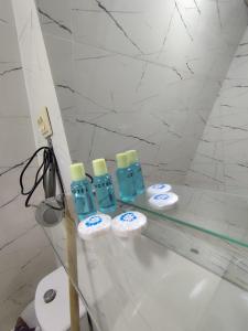 a group of four bottles on a counter in a bathroom at Mountain paradise in Merisi in Merisi +57 photos