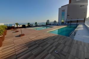 a pool on the roof of a building at SHB - Refinement, Ocean View, Sauna and Pool! in Santos