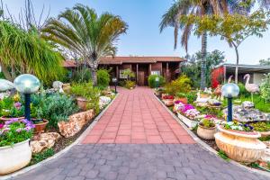 a garden with a brick walkway in front of a house at הבקתות של רחל in Kahal