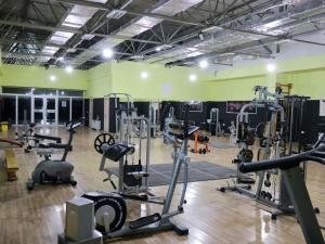 a gym with treadmills and machines in a room at Arena Hotel Shirvan in Əli Bayramlı Stansiyası