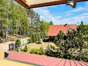 a view of a house with a red roof at Domek całoroczny in Swornegacie
