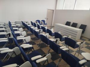 an empty room with blue chairs and a whiteboard at Arena Hotel Shirvan in Əli Bayramlı Stansiyası +7 photos
