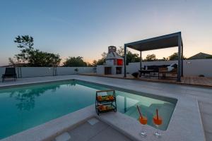 a swimming pool with a table and a couch at Villa Roma Murvica ZadarVillas in Murvica