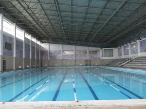 a large swimming pool with blue water at Arena Hotel Shirvan in Əli Bayramlı Stansiyası
