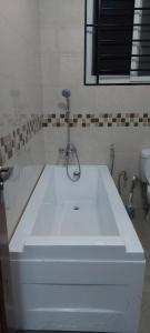 a white sink with a faucet in a bathroom at Serene BnB - Apt 07 Makongo after Mlimani City in Dar es Salaam